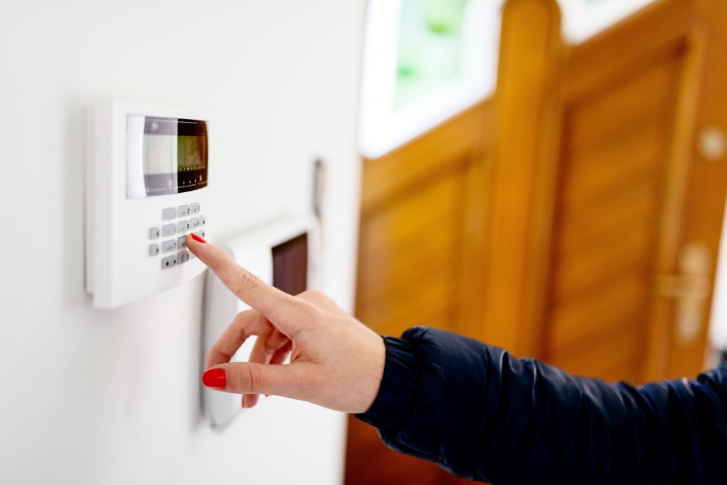 Woman entering the home alarm security code