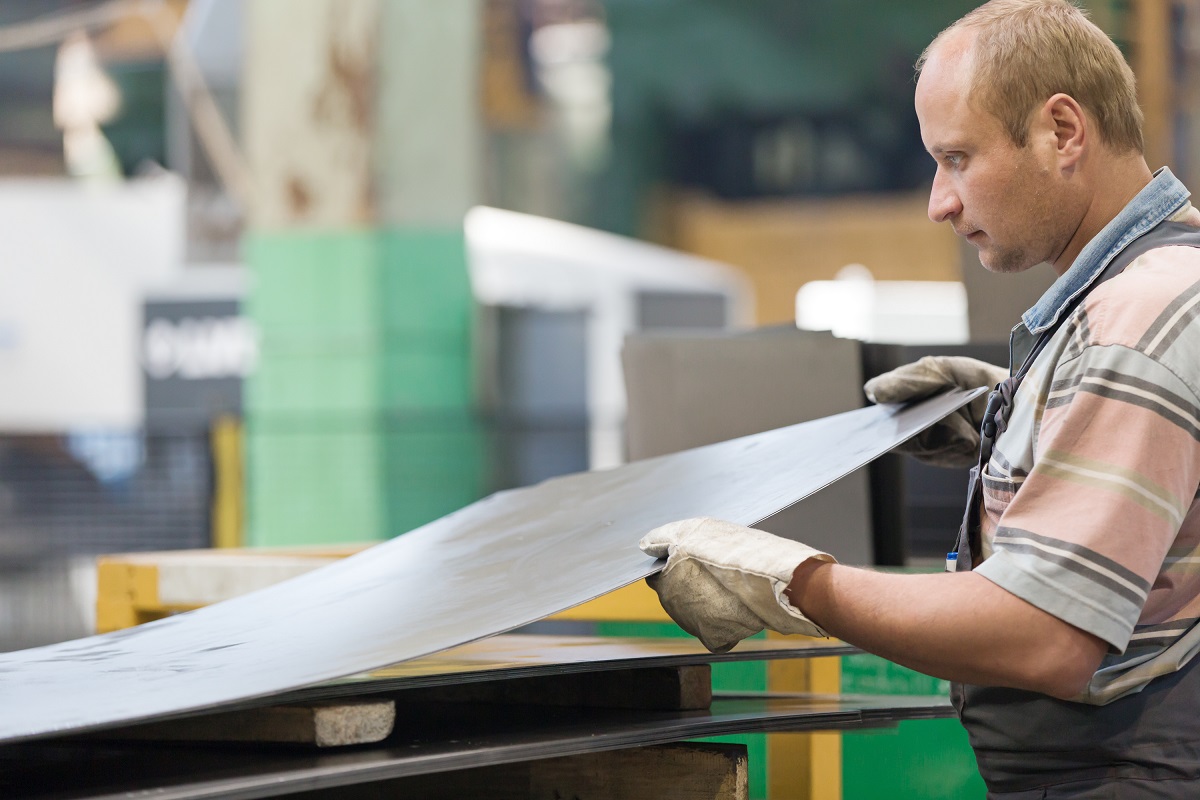 Worker holding a metal sheet