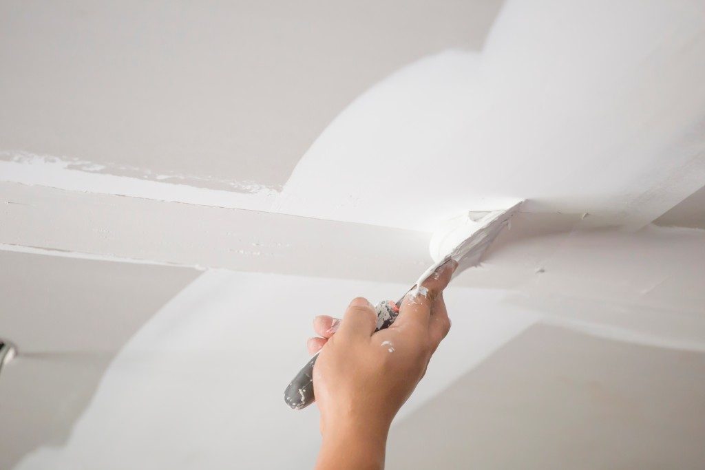 Worker dry lining the house