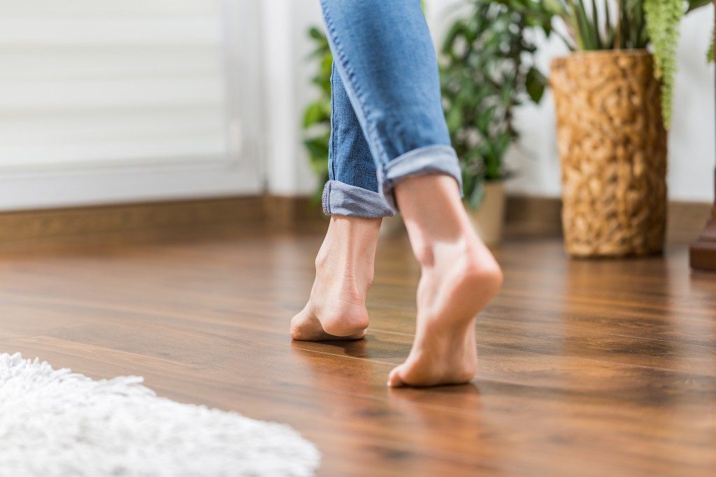 wood flooring with barefoot woman walking