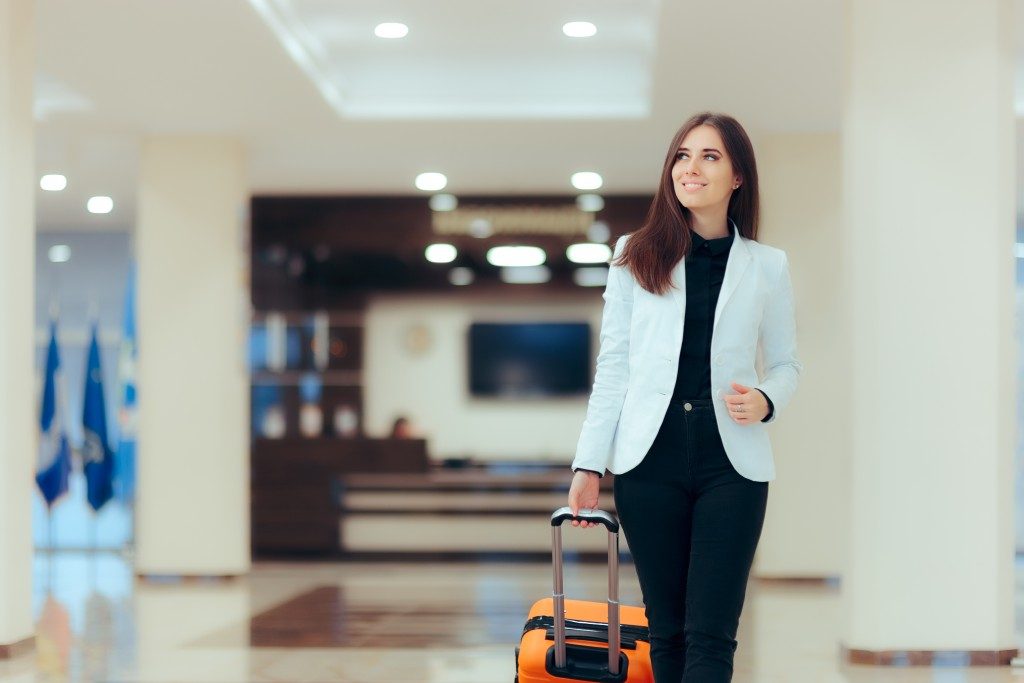 Woman walking in an airport with her luggage