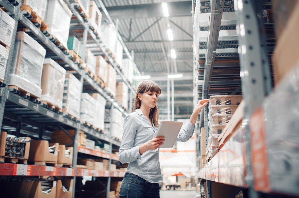 woman checking out stuff in the warehouse