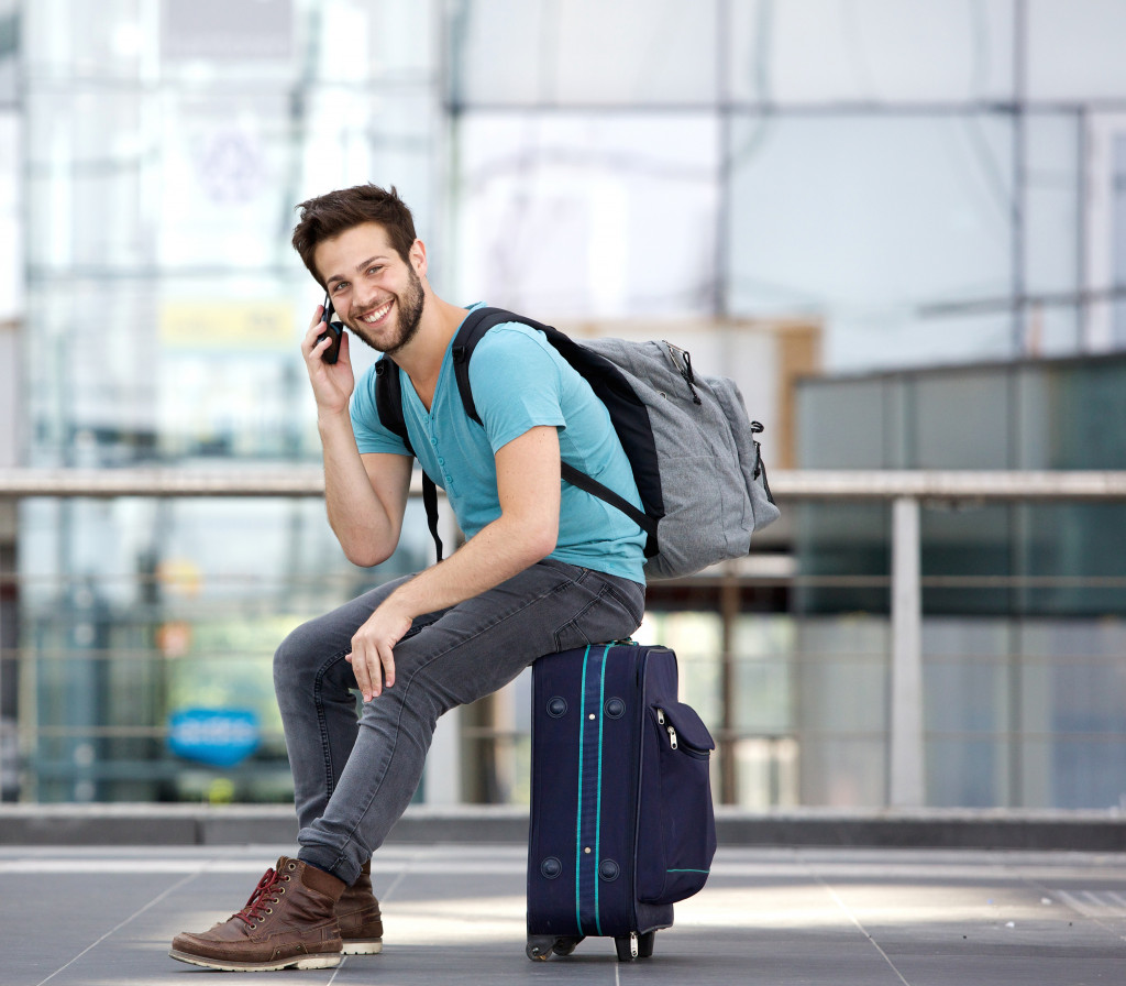 traveler sitting on his bag