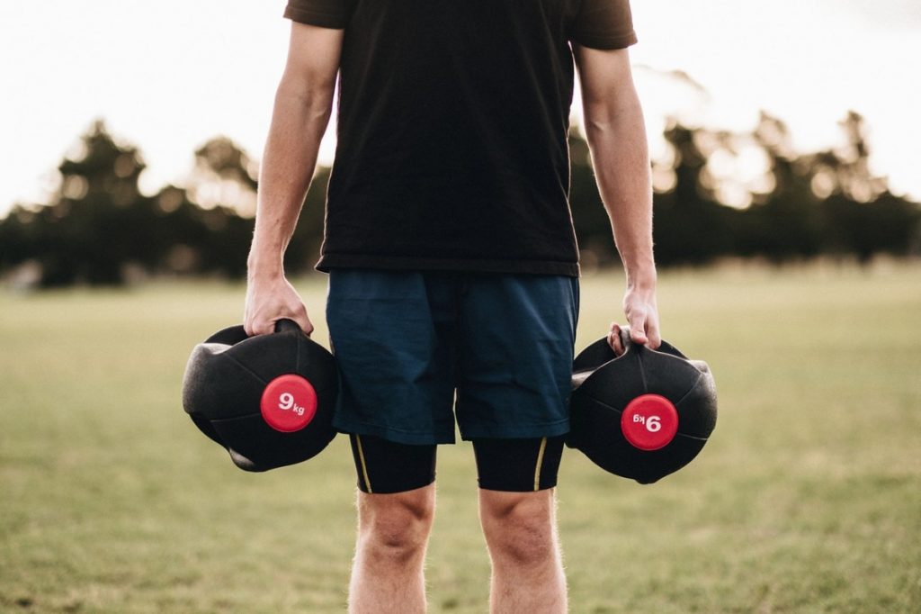 man holding dumbbells