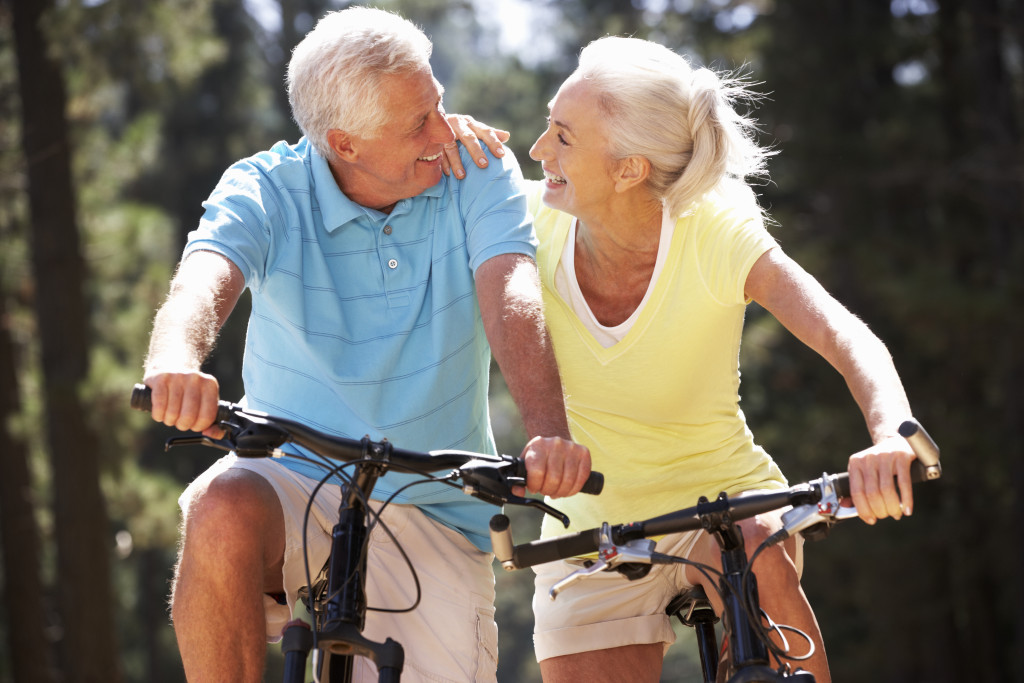 two older people riding on a bike