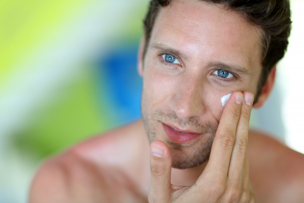 a man applying skincare