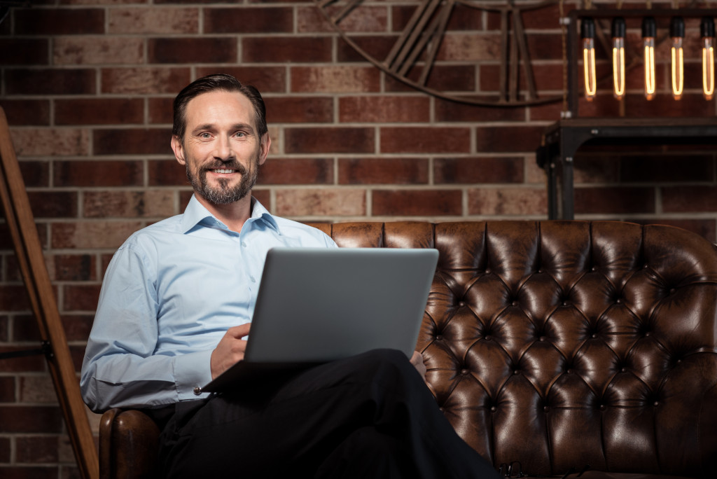 a man holding a computer