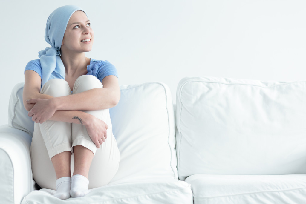female cancer patient smiling in the white couch