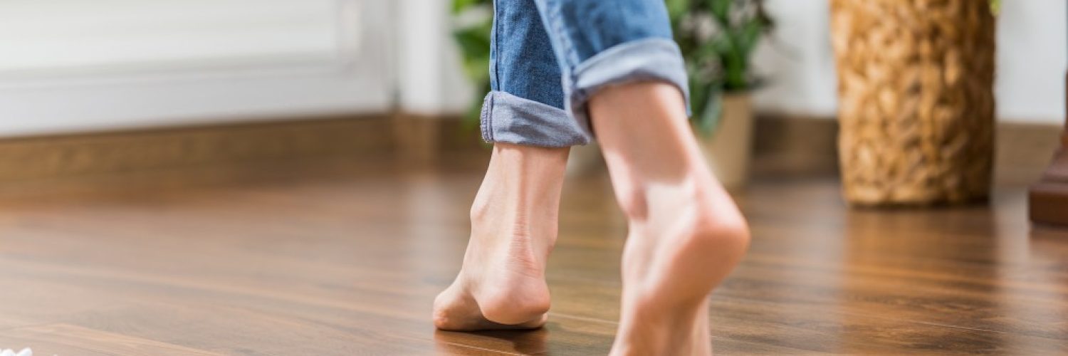 wood flooring with barefoot woman walking