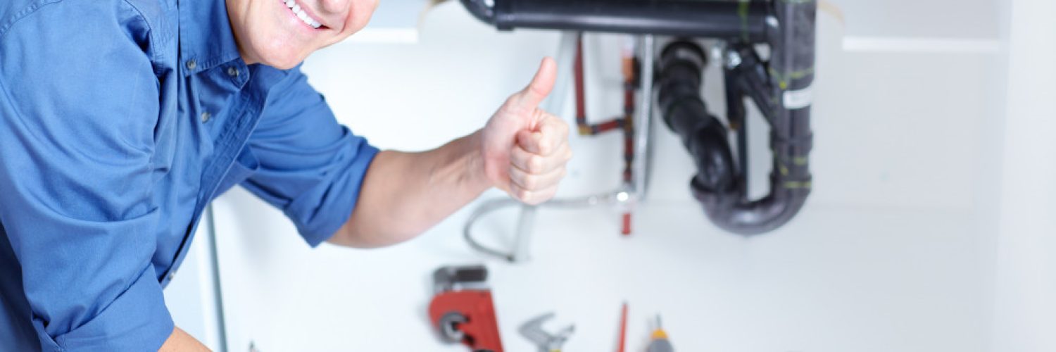 A professional plumber giving a thumbs up after doing his work